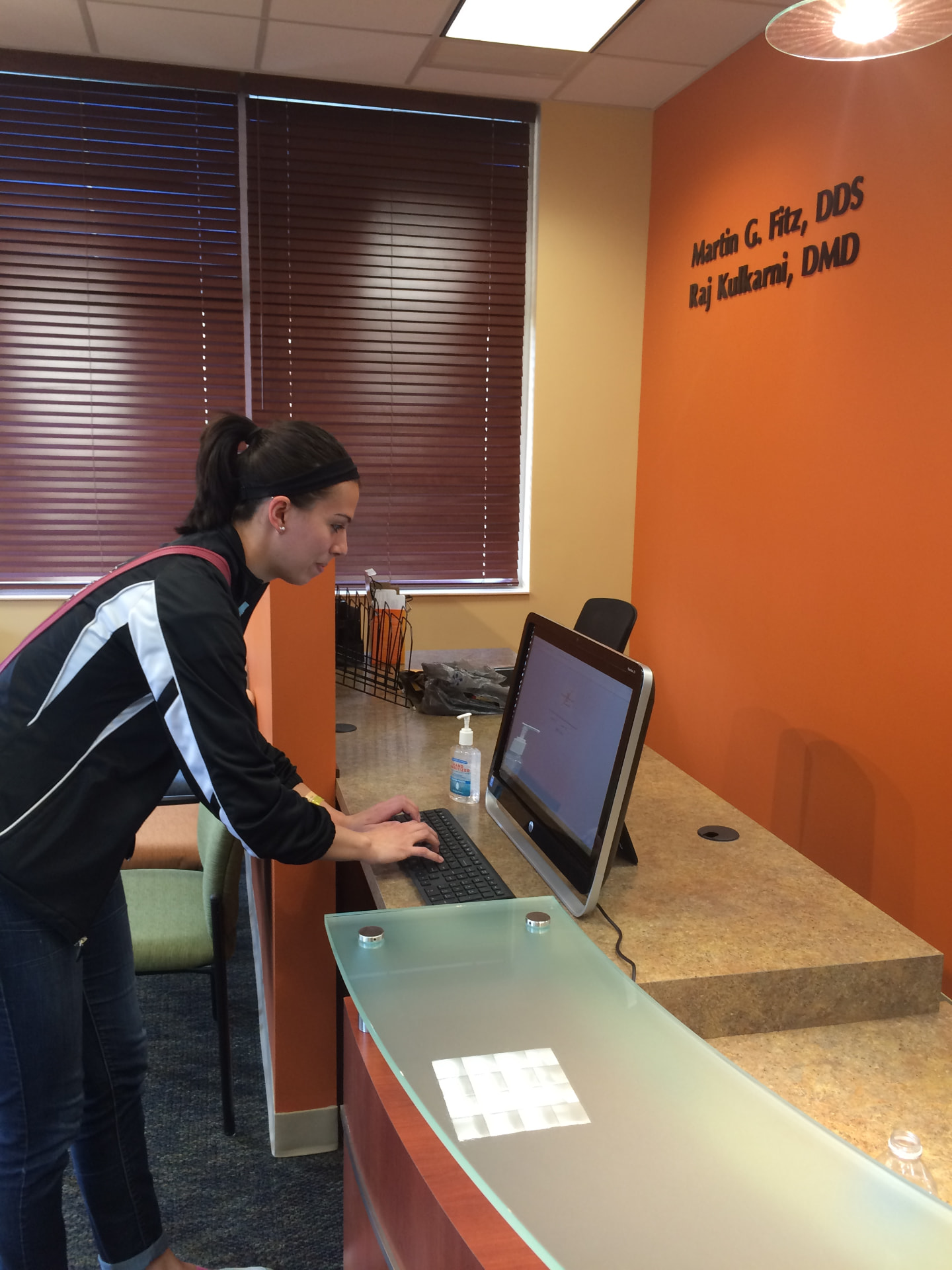 A patient using the self check-in station at the front desk