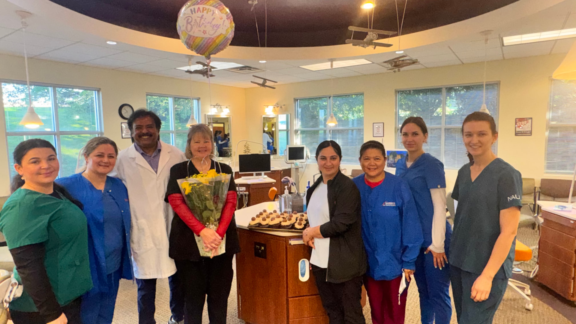 Kulkarni Orthodontics team celebrating together in the office
