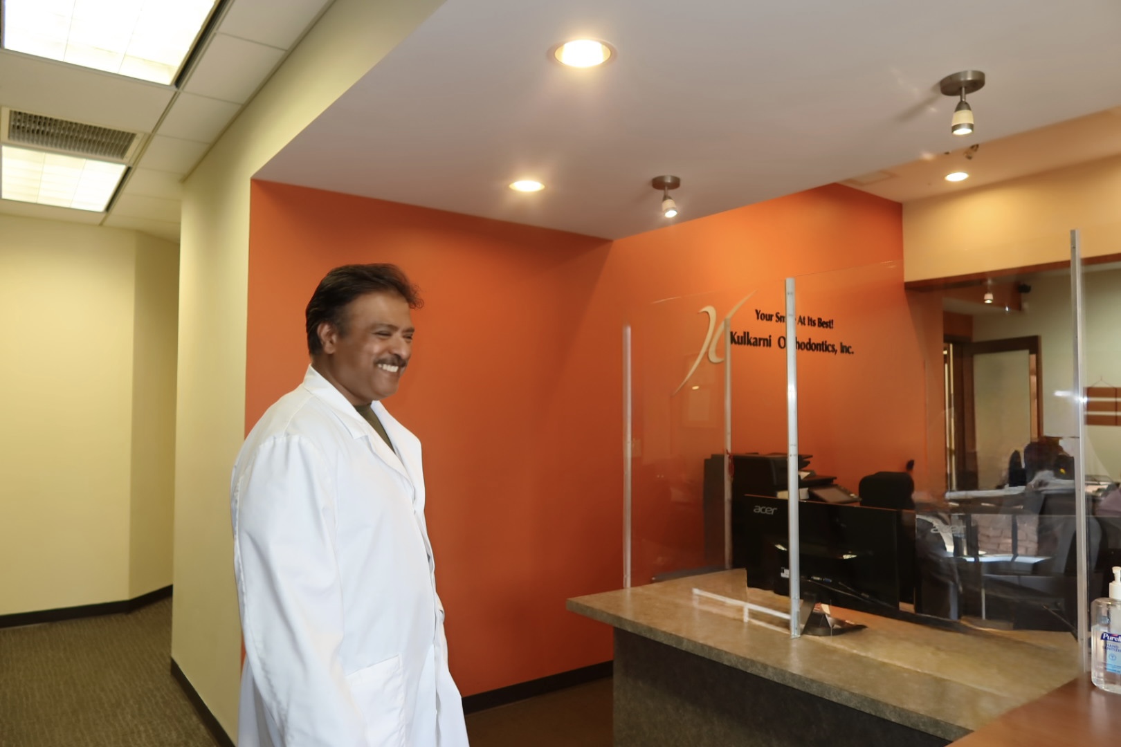 Dr. Raj Kulkarni at the Kulkarni Orthodontics front desk