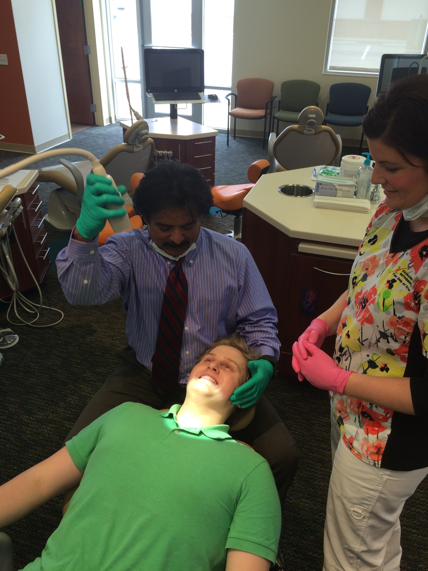 Dr. Kulkarni and an orthodontic assistant caring for a patient chairside