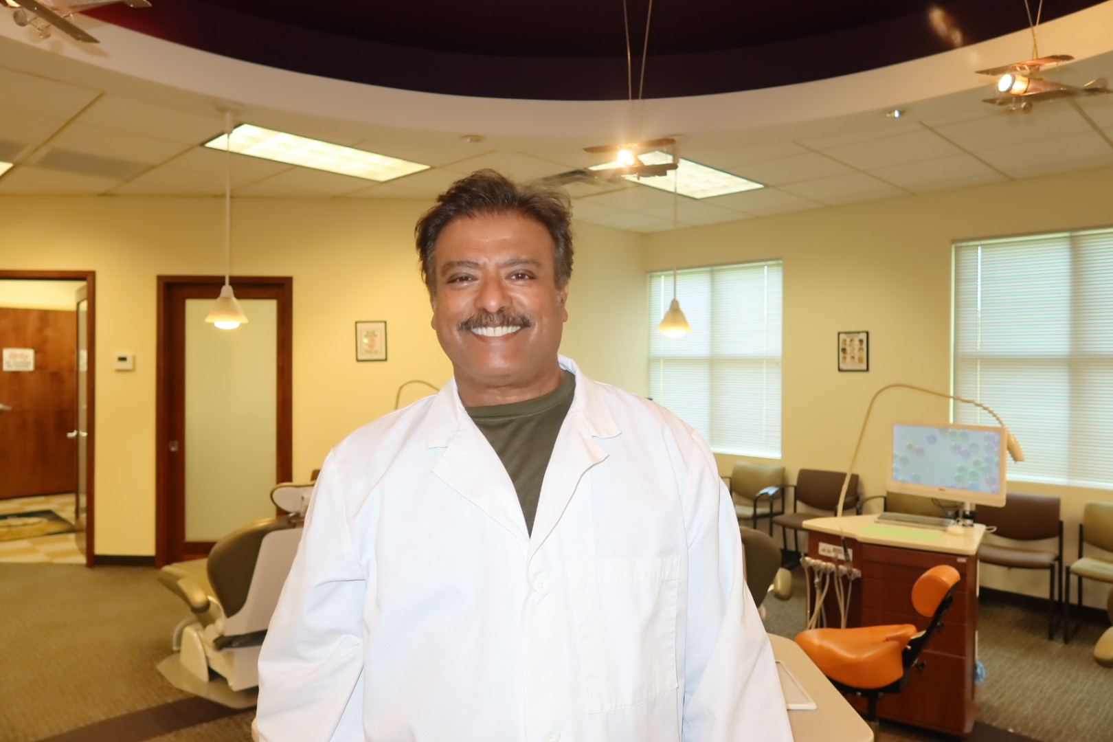 Dr. Raj Kulkarni smiling in the Kulkarni Orthodontics treatment room